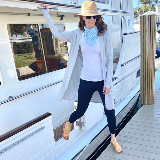 woman wearing eclipse duster and eclipse gaiter on her boat