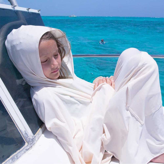 Girl wearing the upf50 eclipse equinox cover-up on a boat