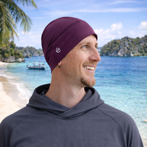 man wearing the elcipse Beanie in plum on the beach in Bali