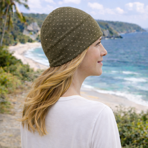 woman on the beach wearing the eclipse beanie in starry night