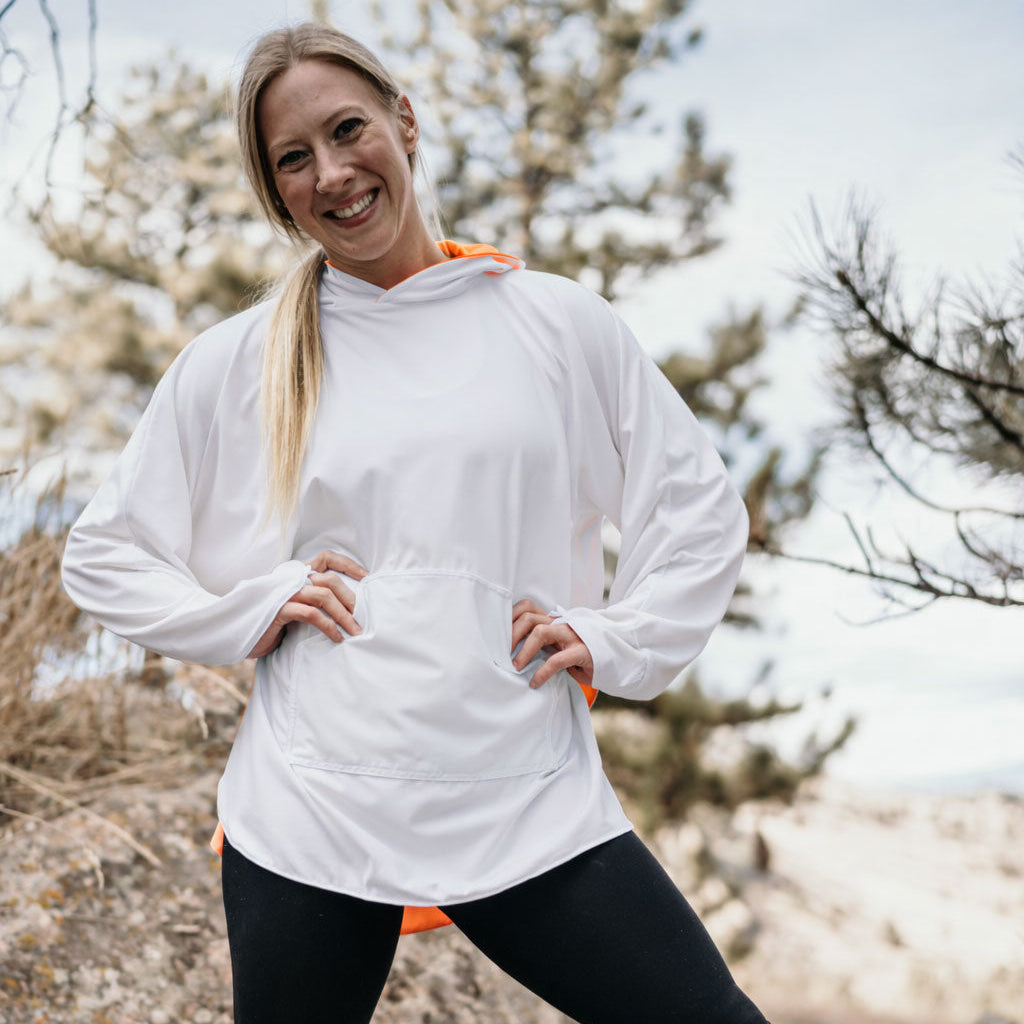 woman in white eclipse Equinox Reversible cover-up in the mountains