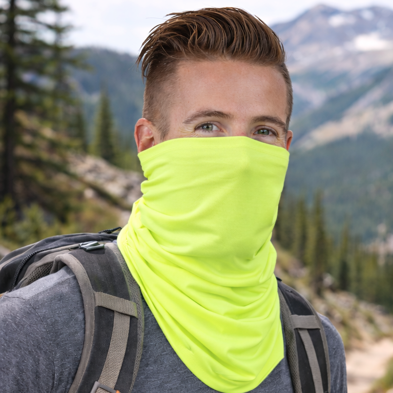 Person hiking in a mountainous area wearing a neon eclipse Gaiter.