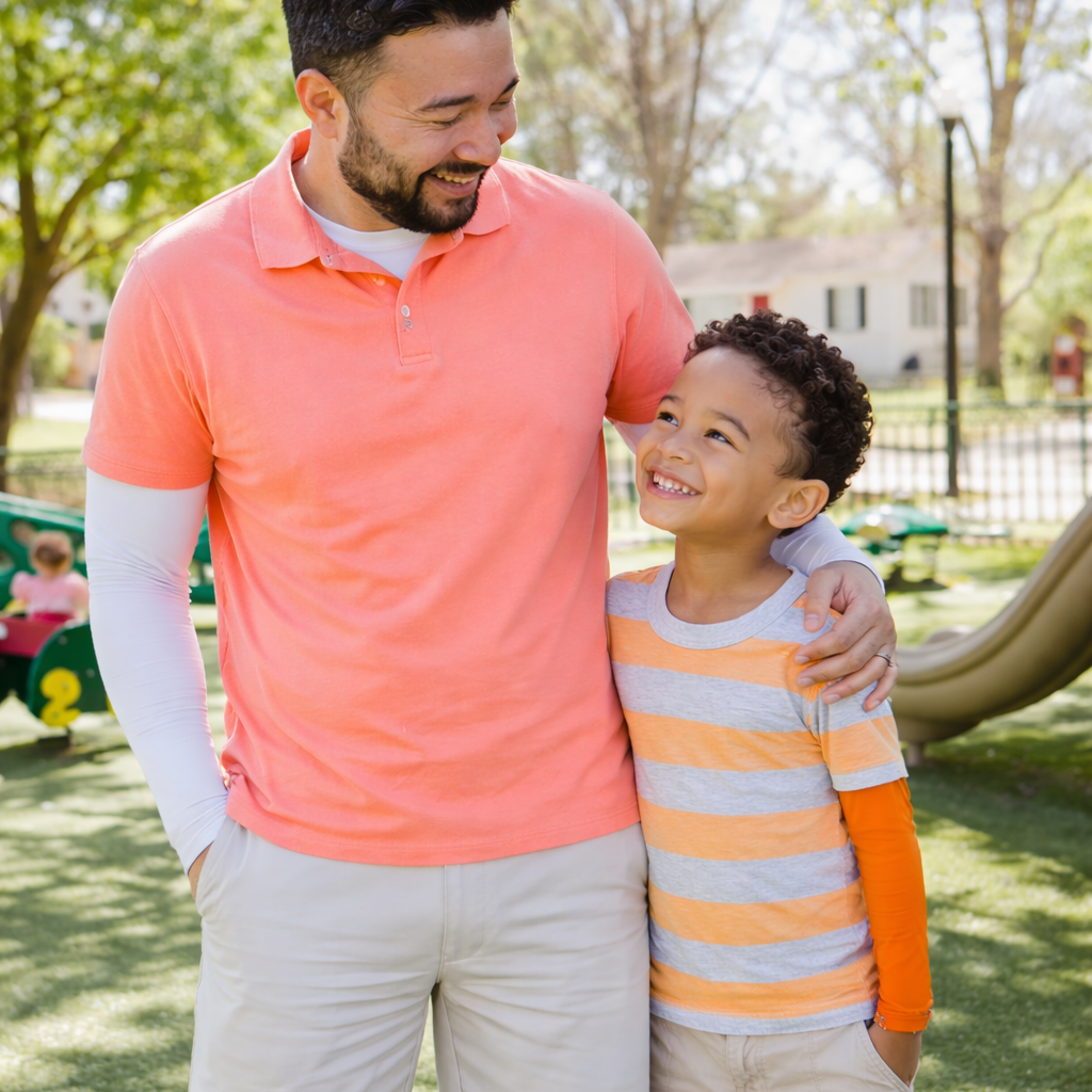 father and son in eclipse sun sleeves at the playground