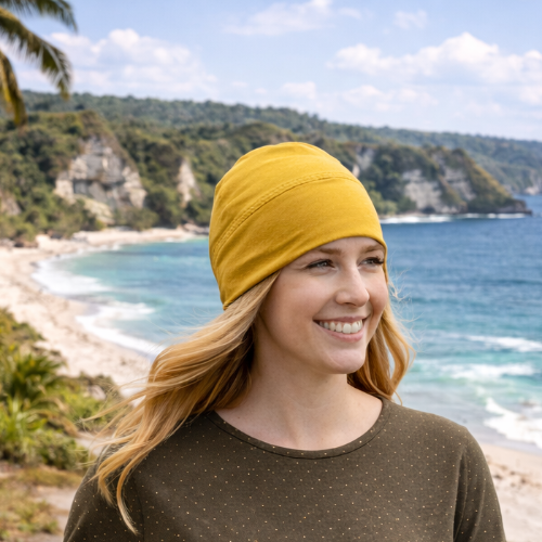 woman walking in bali while wearing the eclipse beanie in turmeric